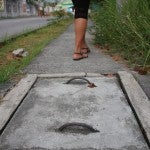 Woman walking on sidewalk