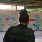 Woman looks at maps of Pasadena