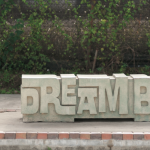Image of bench in East End that says "Dream Big"