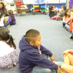 Kindergarten students in the classroom smiling 