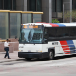 People walking to Metro bus in downtown