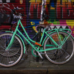 Bicycle against wall with graffiti 