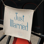 Just married sign hanging off the back of a carriage