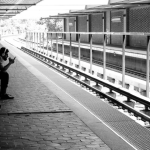 Man waiting at transit stop