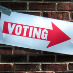 Voting Sign on Brick Wall