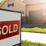 Sold sign in front of home