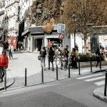 people walking on street near white concrete building during daytime photo – Free Human Image on Unsplash