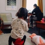 child at home with working mother