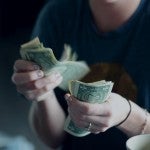 Woman counting money cash