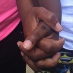 Two hands holding each other