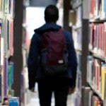 student walking through school library