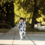 Girl walking on sidewalk