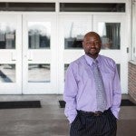 Roderick Scott in front of school