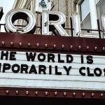 theater marquee reading the world is temporarily closed