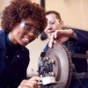 students working on a car