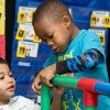 Pre-K students work on a structure in class