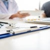 A patient and doctor discuss medical matters in an office.
