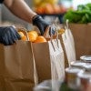 A food pantry worker collects and distributes groceries.