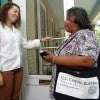 Census workers speaking to people at their doorway