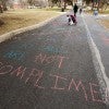 "Cat calls are not compliments" written in chalk on pavement "Cat calls are not compliments" written in chalk on pavement