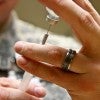 Man pulling vaccine from vile into syringe. Man pulling vaccine from vile into syringe.