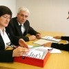 Three people in business clothes conducting an interview