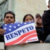 Man holding sign with the American flag on it saying, "Respeto"