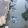 Flooded apartment building and cars