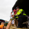 Baby being passed by rescue official