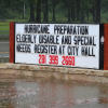 Sign during flood saying "Hurricane preparation" help lines Sign during flood saying "Hurricane preparation" help lines