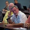 Man speaking to a group of other men