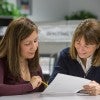 Woman helping another woman
