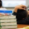 A student at the Elsik Ninth Grade Center rests during a lesson while participating in an after-school program. Pu Ying Huang for The Texas Tribune