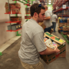 Image of a volunteer carrying a box of food