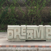 Image of bench in East End that says "Dream Big"