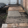 A makeshift wheelchair ramp leading to a house door