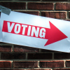 Voting Sign on Brick Wall