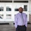 Roderick Scott in front of school