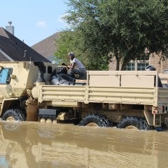 A vehicle makes its way through a neighborhood in the aftermath of Hurricane Harvey, which caused flooding in the region in August 2017.