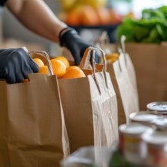 A food pantry worker collects and distributes groceries.
