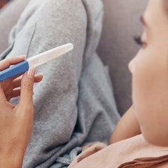 woman looking at a pregnancy test