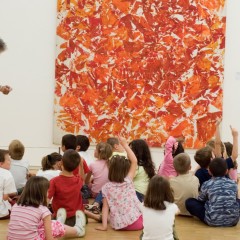 Kids sit in front of painting