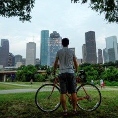 Man with his bike looking at the Houston skyline