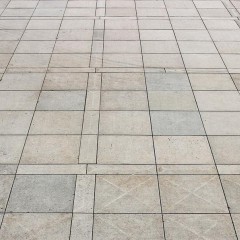 person walks alone in a plaza