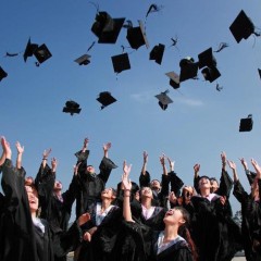 students tossing their graduation caps